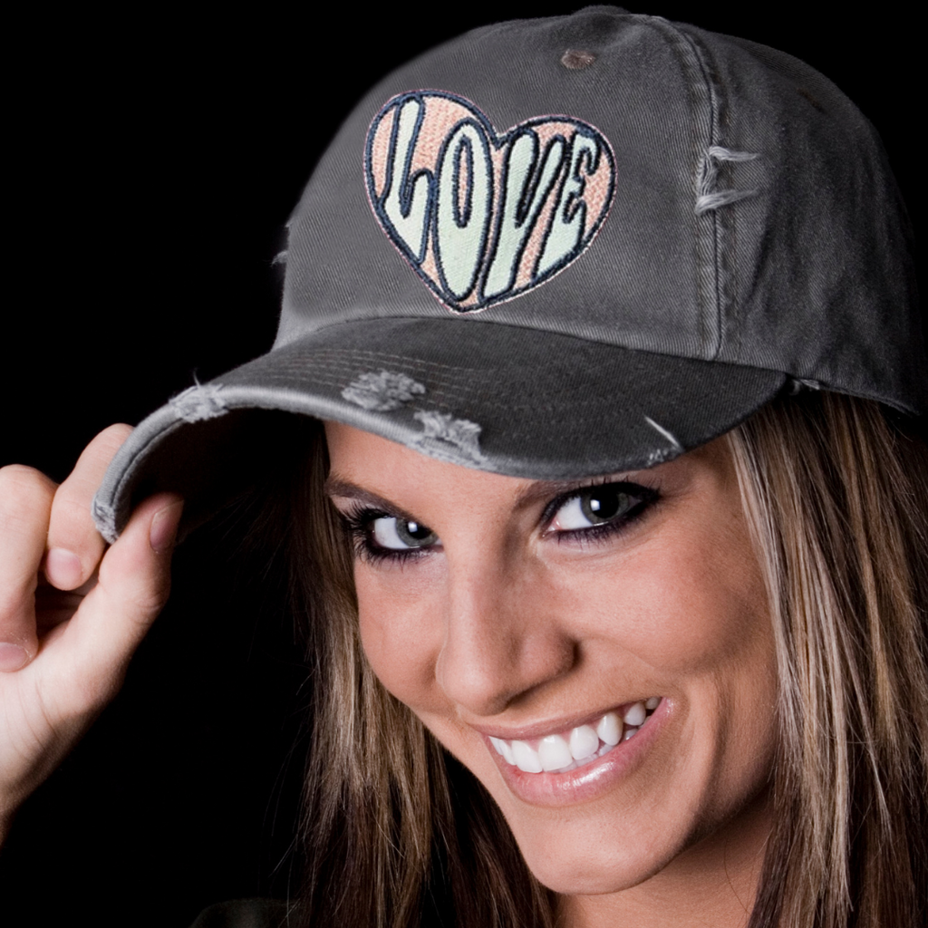 Inspirational hats -Woman wearing a vintage trucker hat saying be kind.