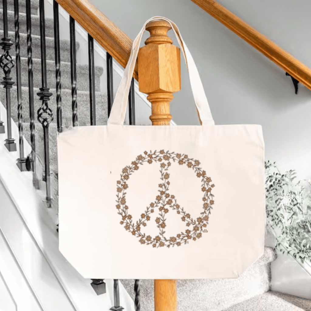Floral Peace Sign Tote Bag on a natural color tote bag displayed on arm of stairway