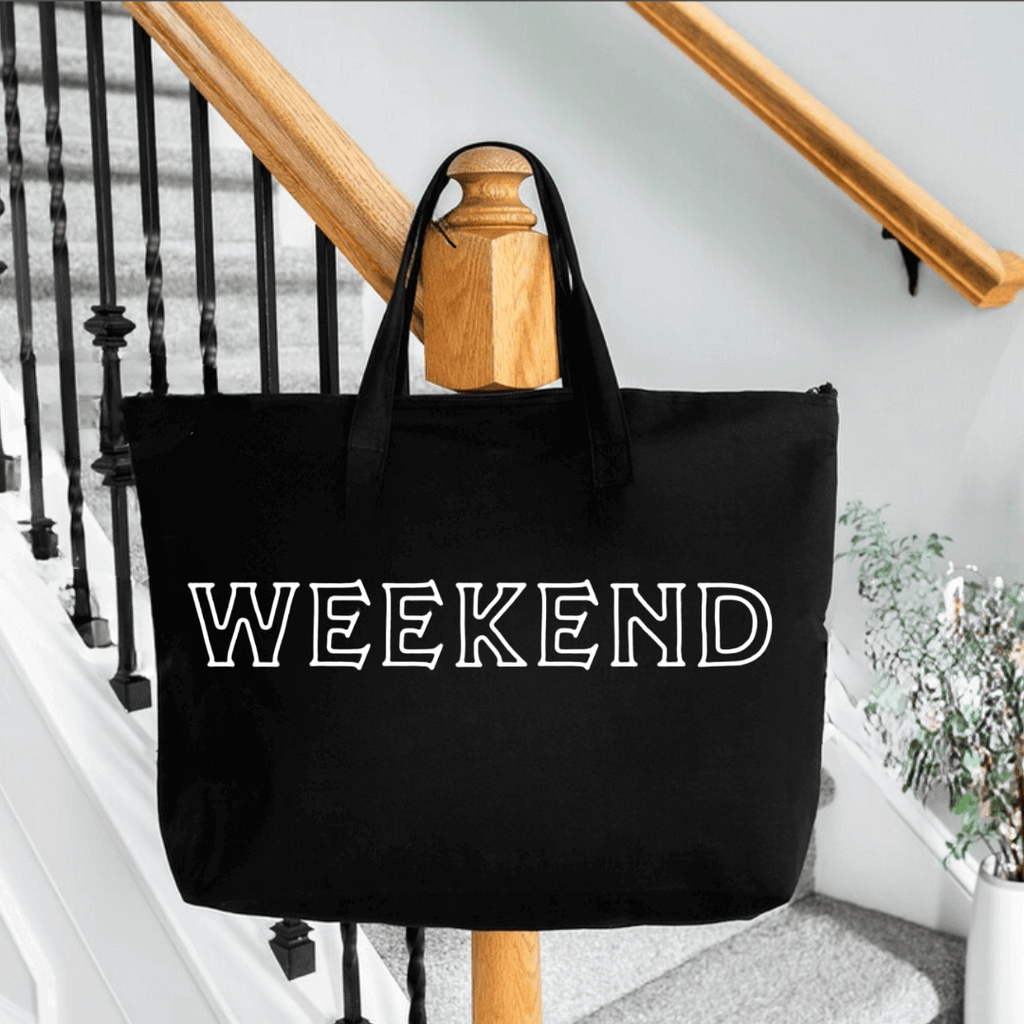  Large Black Tote bag with the word weekend in white screen - displayed on railing of staircase