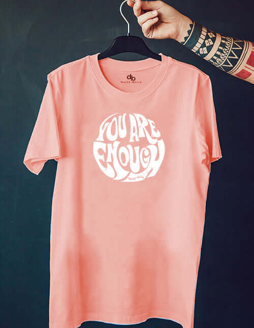 Inspirational t-shirt on a hanger in sunset peach - saying you are enough