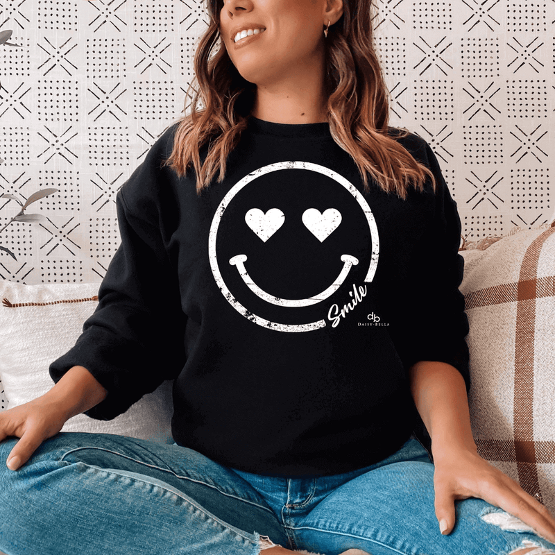Happy Smiley Face Inspirational Sweatshirt on a woman sitting down in black color