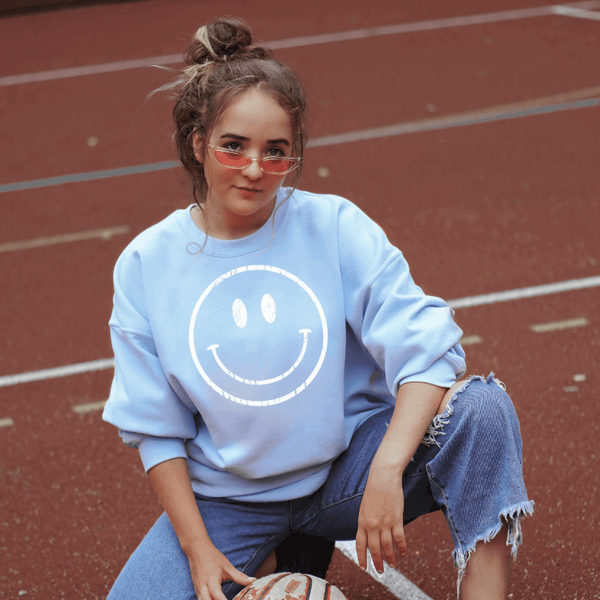 blue sweatshirt with smiley face