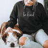 Inspirational sweatshirt saying Be Kind in Black color on a woman sitting down with her dog