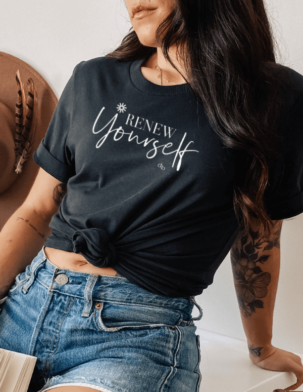 Inspirational shirt - graphics saying Renew Yourself in clack color on model with denim shorts